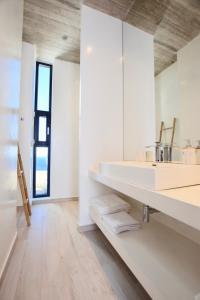 a bathroom with a sink and a mirror at Dream Cave Villa Tinos in Tinos Town