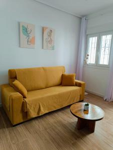 a living room with a couch and a coffee table at Casita El Lagar in Estepona