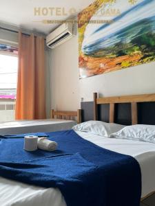 Llit o llits en una habitació de Hotel Novo Gama
