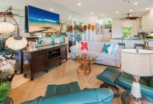 a living room with a couch and a table at 622 Kapalua Ridge Villa in Kahana