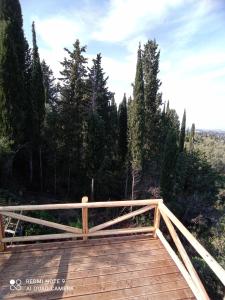 a wooden bridge with trees in the background at Linda House Corfu 2 in Áyioi Dhéka