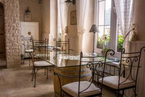 a dining room with chairs and a glass table at Penzion Na Palubě in Mikulovice