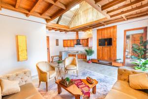 a living room with a couch and a table at Zen Luxus Royal Serene Resort in Kalām