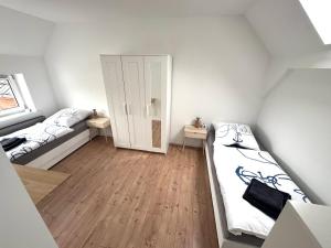a small room with two beds and a door at Große Ferienwohnung in Ostseenähe in Schönberg
