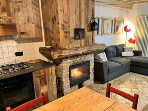 a living room with a couch and a fireplace at Chalet Beatrice in Ledro