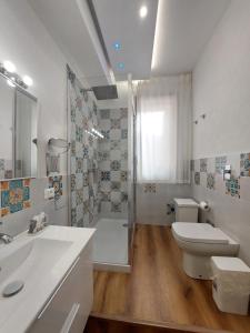 a bathroom with a shower and a toilet and a sink at Cortile 5 Menfi in Menfi