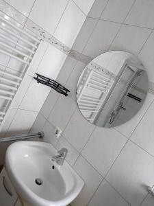 a white bathroom with a sink and a mirror at FeWo Lorenz in Buchen