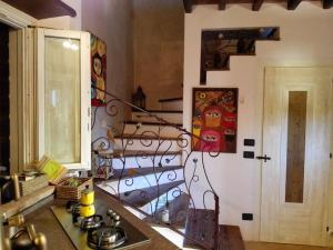 een keuken met een fornuis en een muur met een trap bij La casina-Maisonette in Serramazzoni