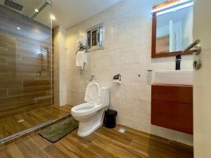 a bathroom with a toilet and a sink and a shower at Swanky apartment in Douala