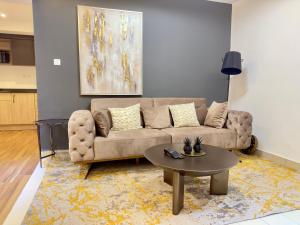 a living room with a couch and a table at Swanky apartment in Douala