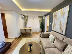 a living room with a couch and a table at Swanky apartment in Douala