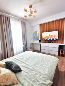 a bedroom with a bed and a tv in it at Jabe Suites in Bacolod +13 photos
