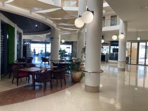 a dining room with tables and chairs in a building at Hibernian 10.02 in Cape Town
