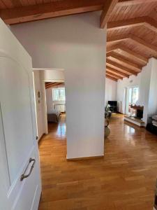 a living room with wooden ceilings and a wooden floor at LOFT HOUSE in Vrachati