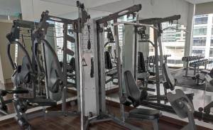 a row of tread machines in a gym at Roomy Suites @One Bukit Ceylon in Kuala Lumpur