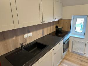 a kitchen with a sink and a counter top at Große Ferienwohnung in Ostseenähe in Schönberg