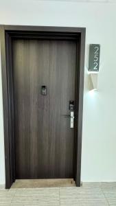 a wooden door in a building with a sign on it at Stylish Condo In Tribeca in San Pedro Sula
