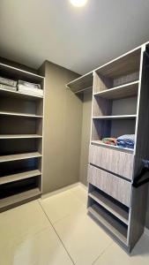 a walk in closet with empty shelves in a room at Stylish Condo In Tribeca in San Pedro Sula