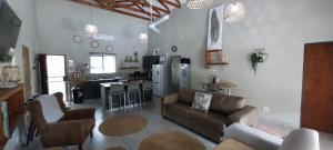 a living room with a couch and a kitchen at Sonador Bush House, 4bedr, 3bathr in Marloth Park in Marloth Park