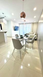 a dining room with a table and chairs at Stylish Condo In Tribeca in San Pedro Sula
