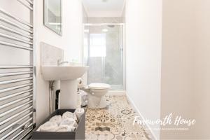 a bathroom with a sink and a toilet at Farnworth Contractor Accommodation in Farnworth