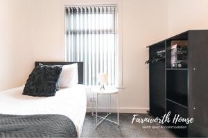 a bedroom with a bed and a window at Farnworth Contractor Accommodation in Farnworth
