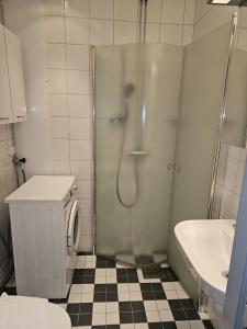 a bathroom with a shower and a toilet and a sink at Live and Stay Lagerbring in Gothenburg