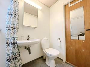 a bathroom with a white toilet and a sink at City View & Central Location in Trondheim