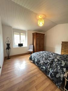 Un dormitorio con una cama y un televisor. en Chez Jean-Jean, en Chantonnay