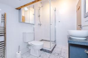 a bathroom with a toilet and a shower and a sink at The Loft Suite - Cheadle in Cheadle Hulme