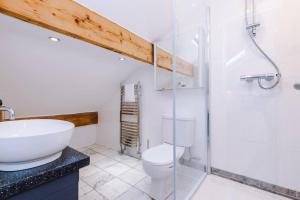 a bathroom with a sink and a toilet and a shower at The Loft Suite - Cheadle in Cheadle Hulme