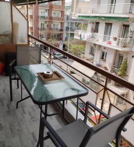 une table et des chaises sur le balcon d'un bâtiment dans l'établissement Papoulias Suite, à Thessalonique