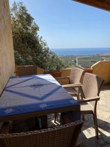 a blue table and chairs on a patio with a view at Evgoro in Chania