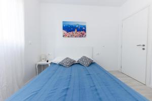 a bed with two pillows on it in a room at Sore in Trogir +47 photos