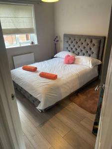 a bedroom with a bed with two pillows on it at Lovely 2 Bed, detached home. in Seacroft