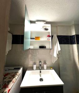 a bathroom with a white sink and a stove at Seaside Apartment Aliki in Kallithea Halkidikis +21 photos