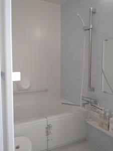 a white bathroom with a shower and a sink at Naoshima Accommodation Menjuku Ura - Vacation STAY 25585v in Naoshima