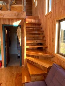 a stairway in a wooden cabin with a stair case at Cabaña con hermosa vista in Ancud