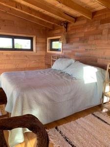 a bedroom with a bed in a wooden cabin at Cabaña con hermosa vista in Ancud