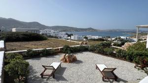 two chairs sitting on a patio with a view of the ocean at Krios Guesthouse in Krotiri