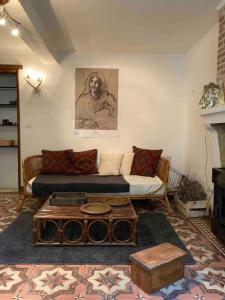 a living room with a couch and a coffee table at Maisonnette de plain-pied plein cœur du perche in Igé