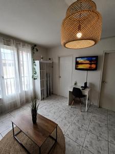a living room with a table and a desk at Couturier lovely appartement proche centre ville in Reims