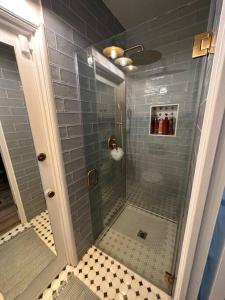 a shower with a glass door in a bathroom at Balboa Island Beach Cottage with Golf Cart in Newport Beach