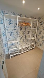 a room with blue and white wallpaper and shelves at IAROS SOL in Santander