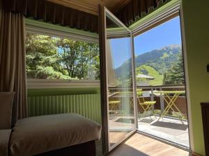 a bedroom with a balcony with a view of a mountain at My Peaceful Retreat in Bormio