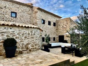 a stone building with a patio in front of it at Luxurious secluded villa in Calaceite