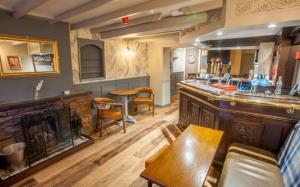 a living room with a bar and a fireplace at The Plough in Sleights