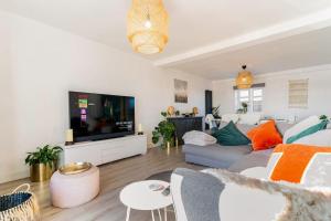 a living room with a couch and a flat screen tv at Stunning Ground Floor Hartlepool Marina Apartment in Hartlepool