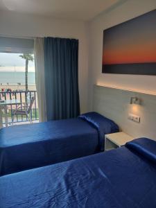 Posteľ alebo postele v izbe v ubytovaní Hotel Rio Mar