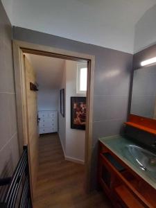 a bathroom with a sink and a mirror at LA TERRASSE in Luchon